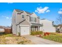 Well-maintained two-story home featuring neutral siding, a one-car garage, and a manicured lawn at 642 Thistle Dr, Burlington, NC 27217