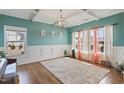 Bright bonus room with hardwood floors, yoga mats, and natural light from multiple windows at 6804 Arlington Oaks Trl, Raleigh, NC 27603