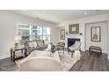 Sunlit living room showcasing modern decor, a cozy fireplace, and dark wood floors throughout at 723 Toulouse Ct, Cary, NC 27519
