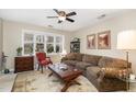 Cozy living room featuring a large window, comfortable seating, and elegant decor at 7925 Brown Bark Pl, Raleigh, NC 27615