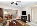 Comfortable living room with fireplace, open to the dining area for easy entertaining at 7925 Brown Bark Pl, Raleigh, NC 27615