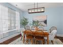 Cozy dining room with wood table, chairs, modern lighting, and an elegant area rug at 80 Ingle View Ct, Burlington, NC 27215