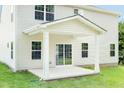 Covered back porch showcasing white pillars and a sliding glass door entrance to the home at 1032 Country Pasture Cv, Wendell, NC 27591