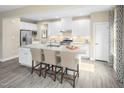 Bright, modern kitchen with white cabinets, a large center island, and stainless steel appliances at 1032 Country Pasture Cv, Wendell, NC 27591