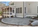 Cozy brick patio area, steps to screened in porch, perfect for outdoor entertaining and relaxation at 105 Jessfield Pl, Cary, NC 27519
