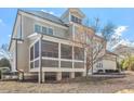 Rear exterior view showcasing a screened porch and patio, offering a relaxed outdoor living space at 105 Jessfield Pl, Cary, NC 27519