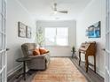 Well-lit office space with a comfortable chair, desk, and a serene view from the window at 106 Ivory Ln, Raleigh, NC 27610