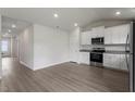 Modern kitchen featuring stainless steel appliances and sleek white cabinetry at 108 Hybrid St, Oxford, NC 27565