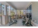 Inviting covered porch with comfortable seating and a view of the surrounding nature at 112 Rawhide Dr, Louisburg, NC 27549