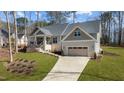 Charming single-Gathering home with a well-manicured lawn, a two-car garage, and a long driveway at 112 Rawhide Dr, Louisburg, NC 27549
