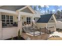Inviting front porch with gray railings offers a welcoming entrance to the beautiful home at 112 Rawhide Dr, Louisburg, NC 27549