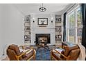 Cozy living room featuring a fireplace, built-in bookshelves, and elegant decor at 112 Rawhide Dr, Louisburg, NC 27549