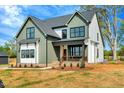 Charming two-story home with black framed windows and cozy front porch at 1403 Antioch Church Rd, Timberlake, NC 27583