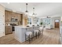 Spacious kitchen with an island, white countertops, pendant lighting, stainless steel appliances, and breakfast bar at 1403 Antioch Church Rd, Timberlake, NC 27583