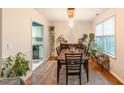 Well-lit dining room featuring a wooden table with chairs, hardwood floors, and leafy houseplants at 200 Lindell Dr, Apex, NC 27539