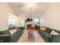 Bright living room showcasing plush couches, a fireplace, and a decorative rug at 200 Lindell Dr, Apex, NC 27539