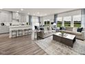Open floor plan features living room and kitchen with hardwood floors and natural light at 2114 Cherry Creek Rd, Haw River, NC 27258