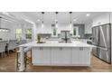 Stunning updated kitchen with a large island, modern pendant lighting, and stainless steel appliances at 2115 Port Royal Rd, Raleigh, NC 27609