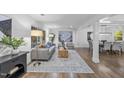 Inviting living room with large windows, hardwood flooring, and neutral decor at 2115 Port Royal Rd, Raleigh, NC 27609