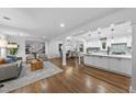 Open-concept living room flows into kitchen and dining area, featuring hardwood floors and bright spaces at 2115 Port Royal Rd, Raleigh, NC 27609