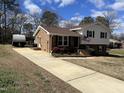 Paved driveway leading up to a brick home with tidy landscaping at 220 Lane Of Sir Gawaine, Garner, NC 27529