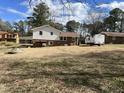 View of the home's back exterior featuring a brick foundation and porch at 220 Lane Of Sir Gawaine, Garner, NC 27529