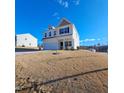 Two-story home with a two car garage, set on a well-manicured lawn under a beautiful blue sky at 265 Forest Meadow Ln, Franklinton, NC 27525