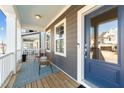 Cozy front porch with comfortable seating, charming rug, and a view of the neighborhood at 283 Dry Canyon Dr, Wendell, NC 27591