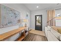 Bright living room features a stylish console table, modern lamp, and a large window with natural light at 283 Dry Canyon Dr, Wendell, NC 27591