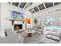 Cozy living room with fireplace, wet bar, vaulted ceilings, and view of the pool area at 3021 Allenby Dr, Raleigh, NC 27604