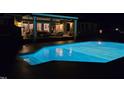 An inviting swimming pool is lit up at night showing access from the home's covered patio at 3021 Allenby Dr, Raleigh, NC 27604