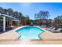 Inviting backyard pool with lounge chairs and views of the lake create a serene outdoor oasis at 3021 Allenby Dr, Raleigh, NC 27604