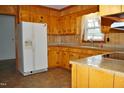 Classic kitchen features wooden cabinets, laminate countertops, and modern appliances at 3359 Huffines Dr, Burlington, NC 27217