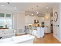 Open floor plan from kitchen into living room with hardwood floors and lots of natural light at 3937 Bentley Brook Dr, Raleigh, NC 27612