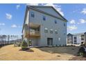 Three-story home with a deck overlooking the yard and a partial fence line at 4724 Cypress Tree Ln, Raleigh, NC 27612