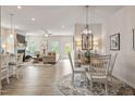 Open-concept living space featuring a dining area, living room with fireplace, and lots of natural light at 4888 Pioneer Dr, Sanford, NC 27330