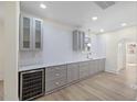 Kitchen featuring grey cabinetry, marble countertops and backsplash, plus wine cooler at 512 S 4Th St, Smithfield, NC 27577