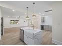 Open-concept kitchen showcasing a marble island with a farmhouse sink, bar, and a wine fridge at 512 S 4Th St, Smithfield, NC 27577