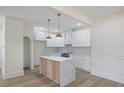 Bright, modern kitchen with white cabinets, a marble island, and stainless steel appliances at 512 S 4Th St, Smithfield, NC 27577