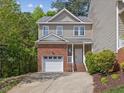 Charming two-story home featuring a brick and vinyl exterior with an attached garage and landscaped front yard at 5945 Four Townes Ln, Raleigh, NC 27616