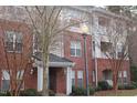 Exterior view of the condo showing the brick facade and private balcony on the upper floor at 622 Ives Ct # 622, Chapel Hill, NC 27514