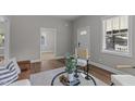 Bright living room featuring wood floors, neutral walls, and stylish modern decor at 703 Vance St, Henderson, NC 27536