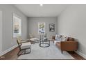 Open living room with leather sofa, modern chairs, and natural light at 703 Vance St, Henderson, NC 27536