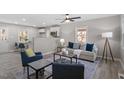 Bright living room with stylish furniture, neutral tones, and hardwood flooring throughout at 838 Waring St, Durham, NC 27704