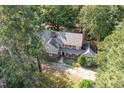 An expansive tree canopy surrounds a brick house and provides a sense of privacy and seclusion from the outside world at 938 Hargrove St, Henderson, NC 27536