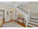 Elegant foyer featuring hardwood floors, decorative wallpaper, staircase and traditional architectural details at 938 Hargrove St, Henderson, NC 27536