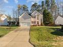 Attractive two-story home with a long driveway and large lawn, offering ample space and curb appeal in a suburban setting at 1006 Scotsburg Trl, Hillsborough, NC 27278
