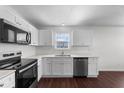 Modern kitchen showcasing stainless steel appliances, white cabinets, and a window over the sink at 101 Wimbledon Ct, Clayton, NC 27520