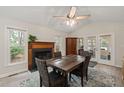 Spacious dining room with a fireplace, stylish furniture, and bright windows allowing natural light at 104 Chris Ct, Cary, NC 27511