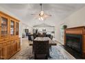 Open-concept view of the dining room with fireplace that flows into the kitchen with an island and pendant lights at 104 Chris Ct, Cary, NC 27511